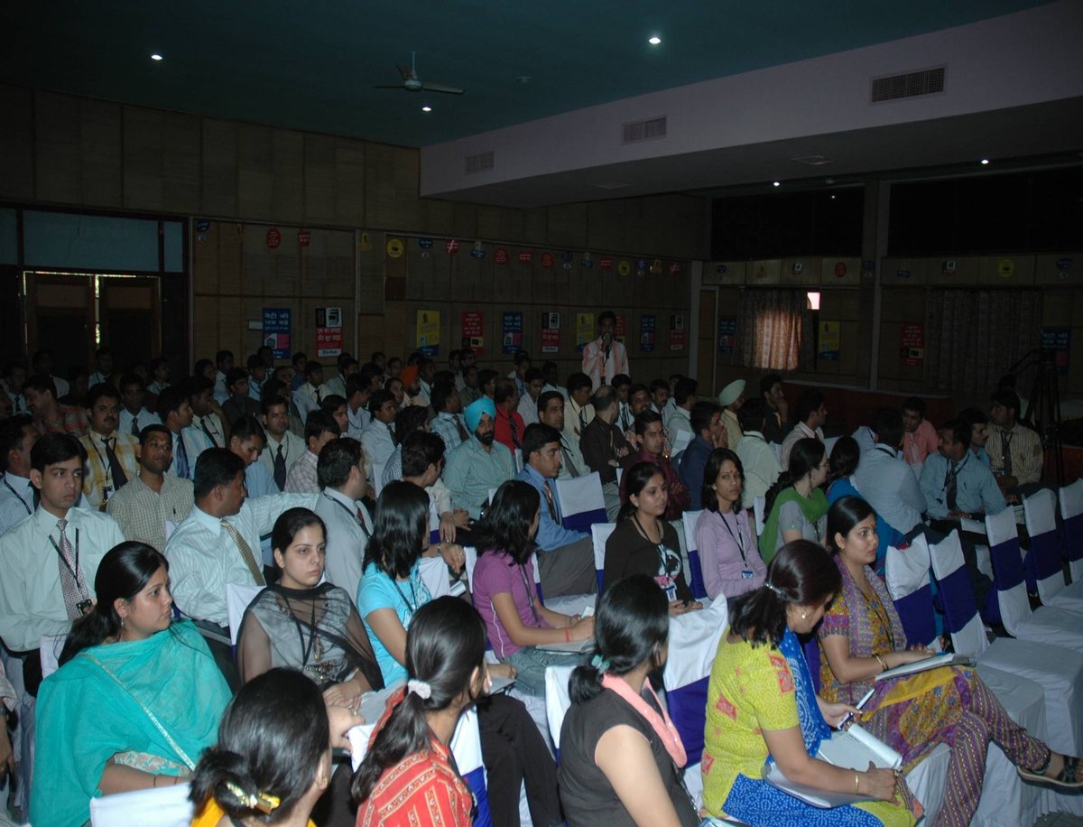 Large seated audience at a Su-Kam educational or sales training event