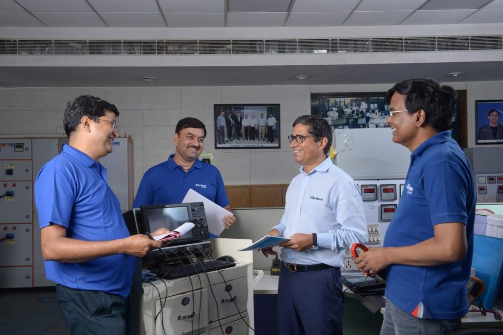 Sanjeev Saini and Su-Kam R&D team members in the lab with oscilloscope and test gear
