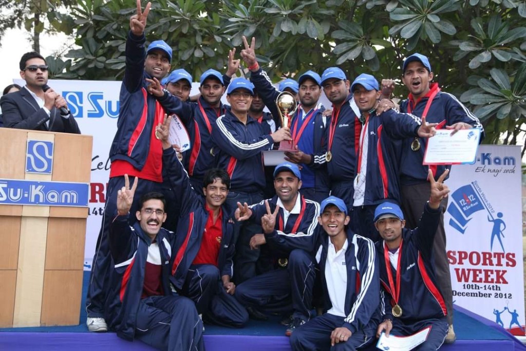 Su-Kam Sports Week 2012 winners on stage with trophy, medals, and certificates