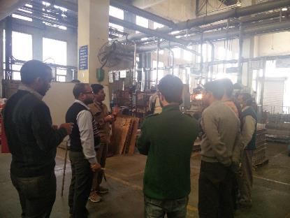 Operators gathered for grid casting training on the battery plant floor