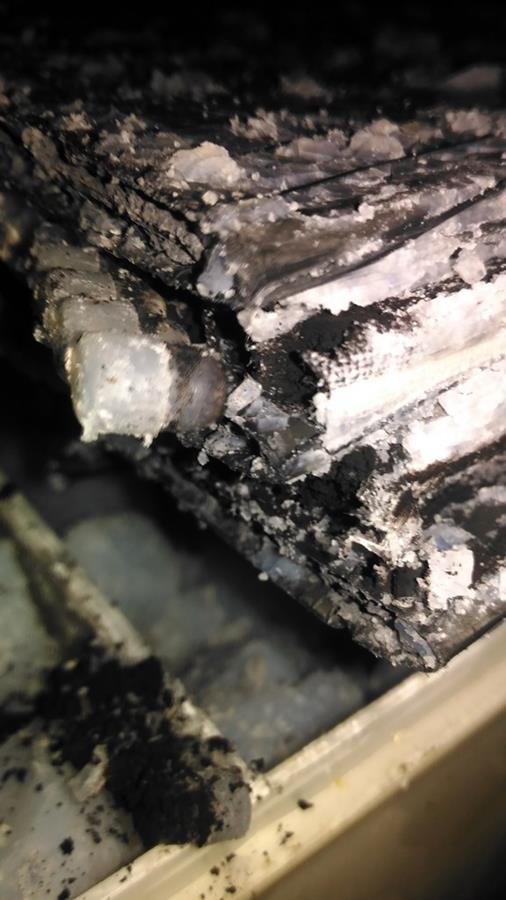 Teardown of life-test tubular gel battery showing corroded positive plate and crystalline deposits