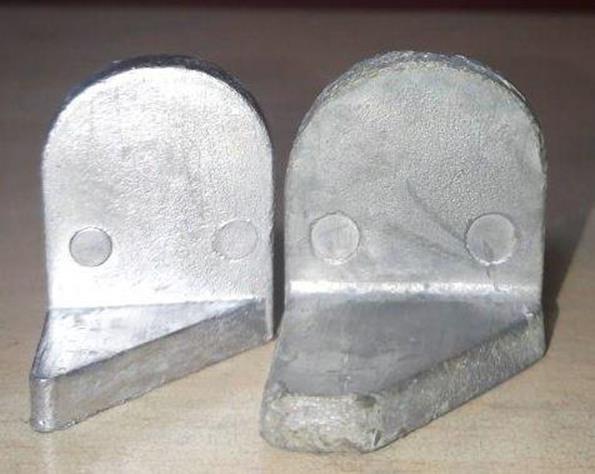 Before and after lead strap castings comparing thicker and optimized strap geometry